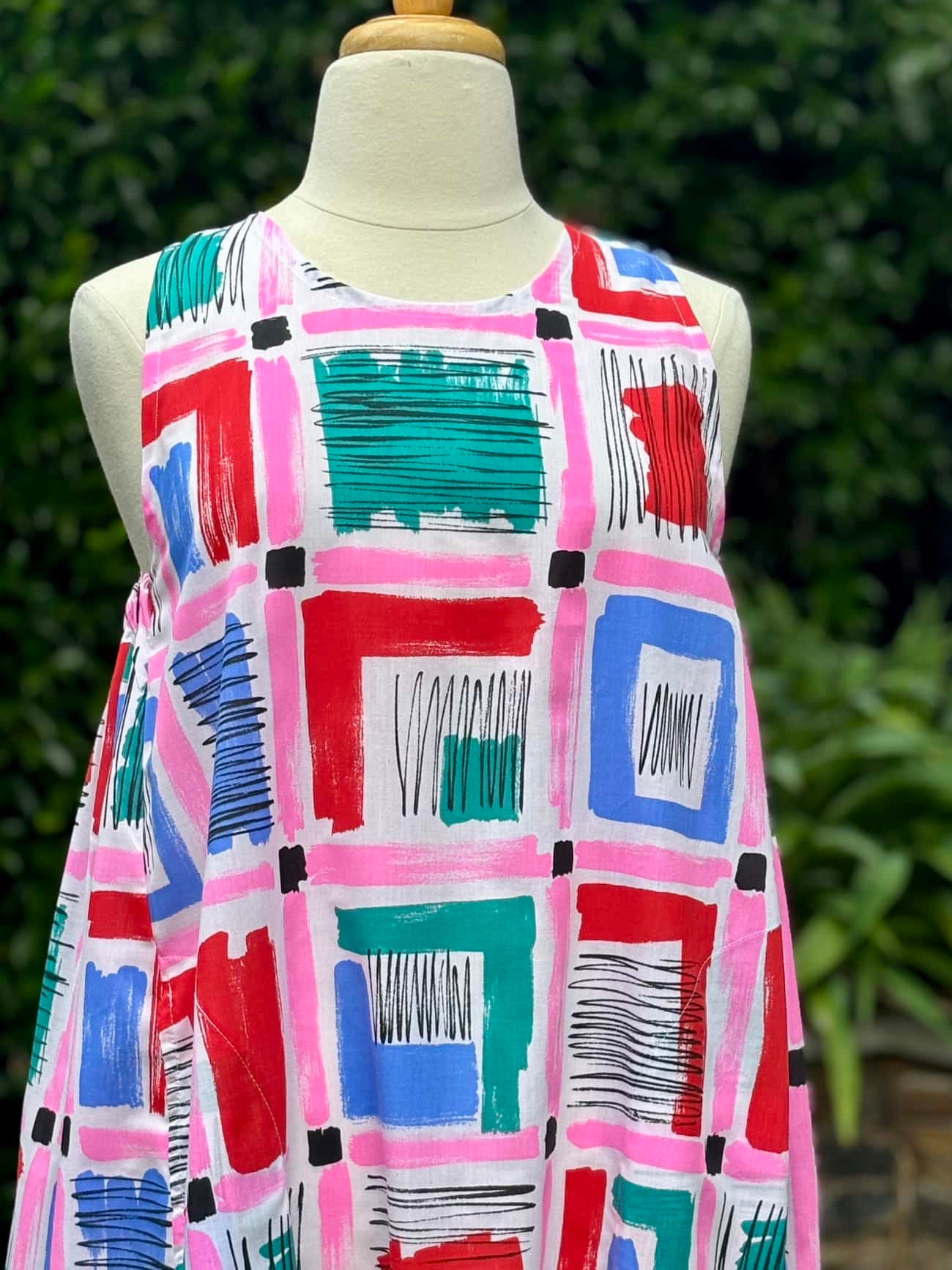 Belinda Pinafore | pink geometric